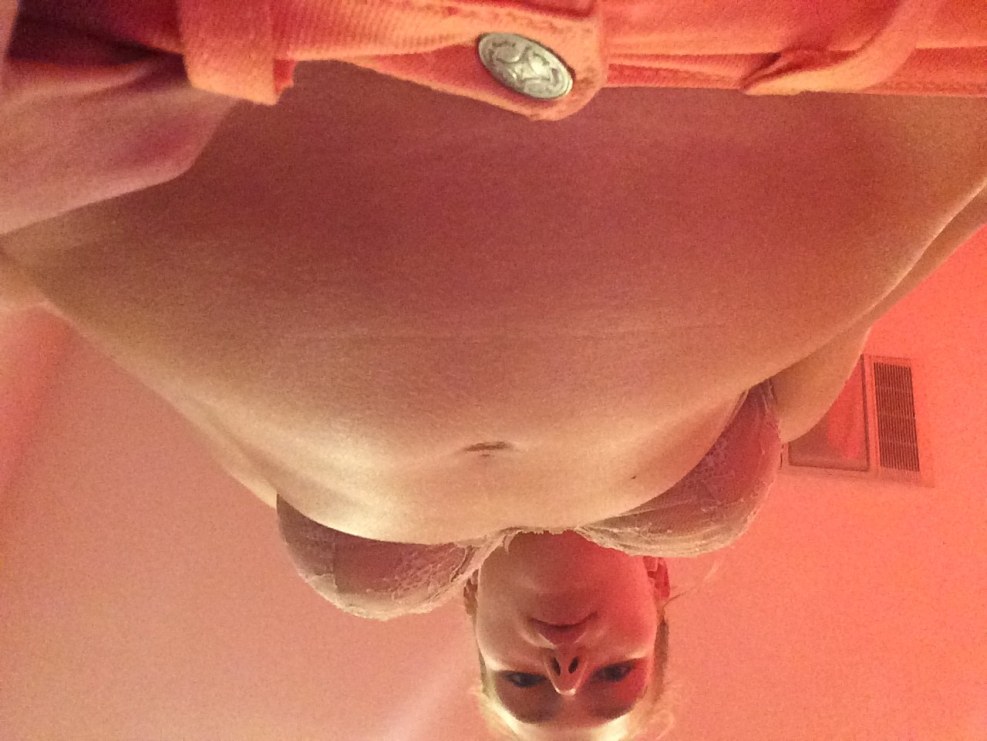 The girl holds a bottle of chest