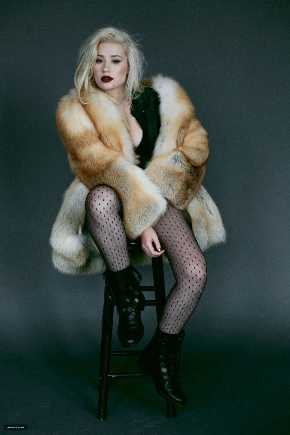 Adult naked woman in a fur coat