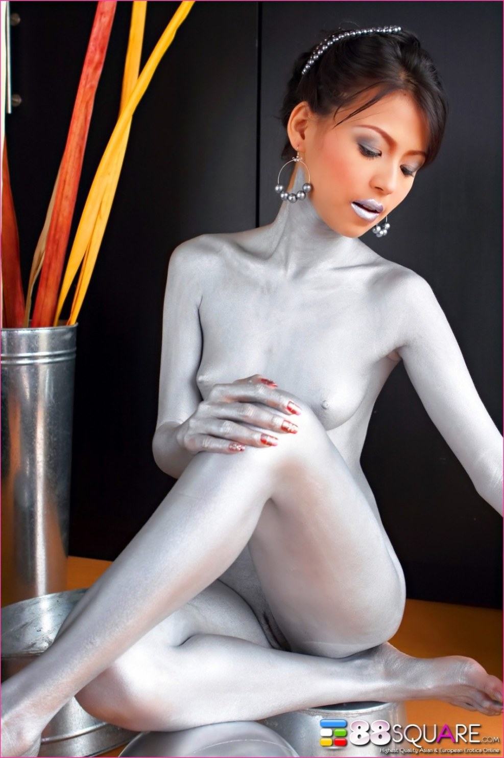 Naked woman in gold paint