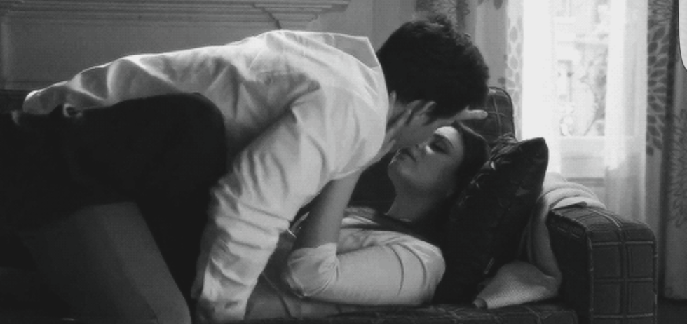 Passionate kiss on the couch