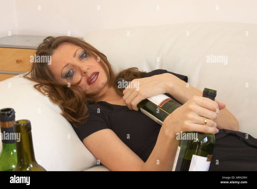 The silhouette of a pregnant woman with alcohol
