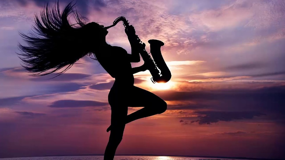 The silhouette of a girl with a saxophone