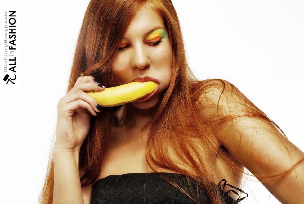 Woman with banana in the mouth